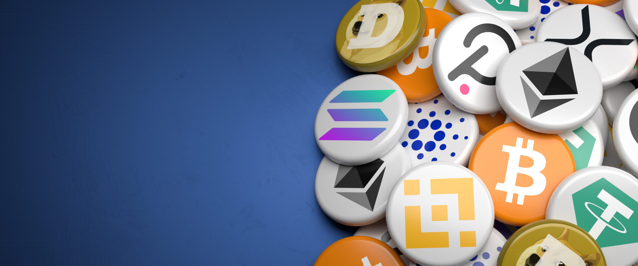 Logos of the main cryptocurrencies Bitcoin, Ethereum, Binance, Cardano, Ripple, Dogecoin, Tether, Solana, Polkadot on a heap on a table. Copy space. Web banner format